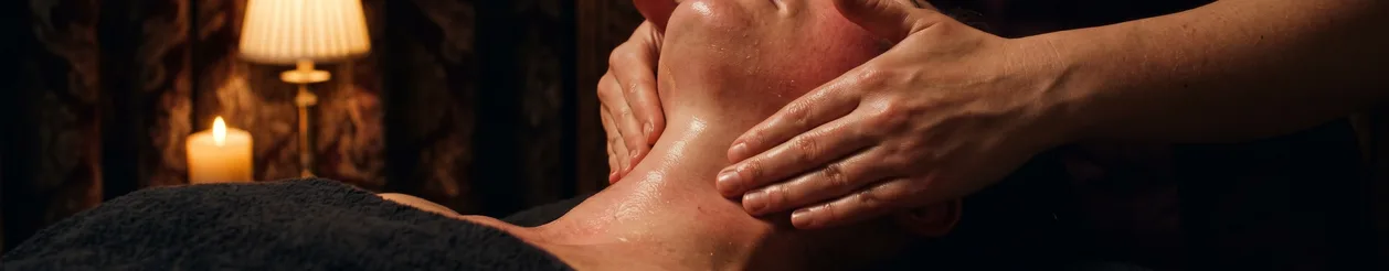 Specialist massaging a guest's jaw and neck