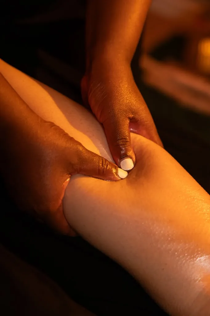 Therapist kneading a client's calf muscle